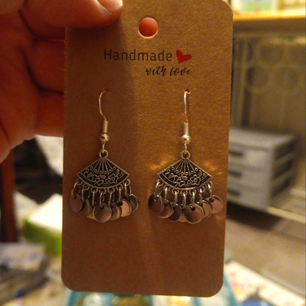 A Pair Of Silver Decor Fans With Dangles Connected.